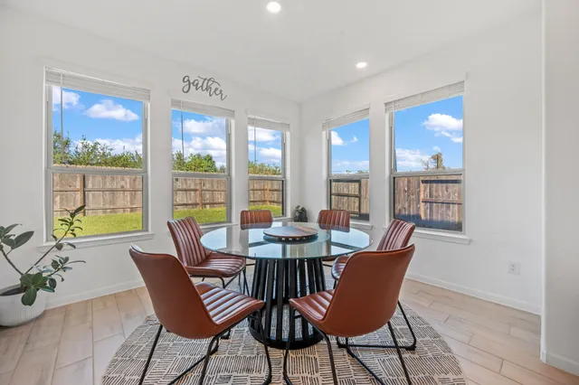 a view of a dining room with furniture window and outside view