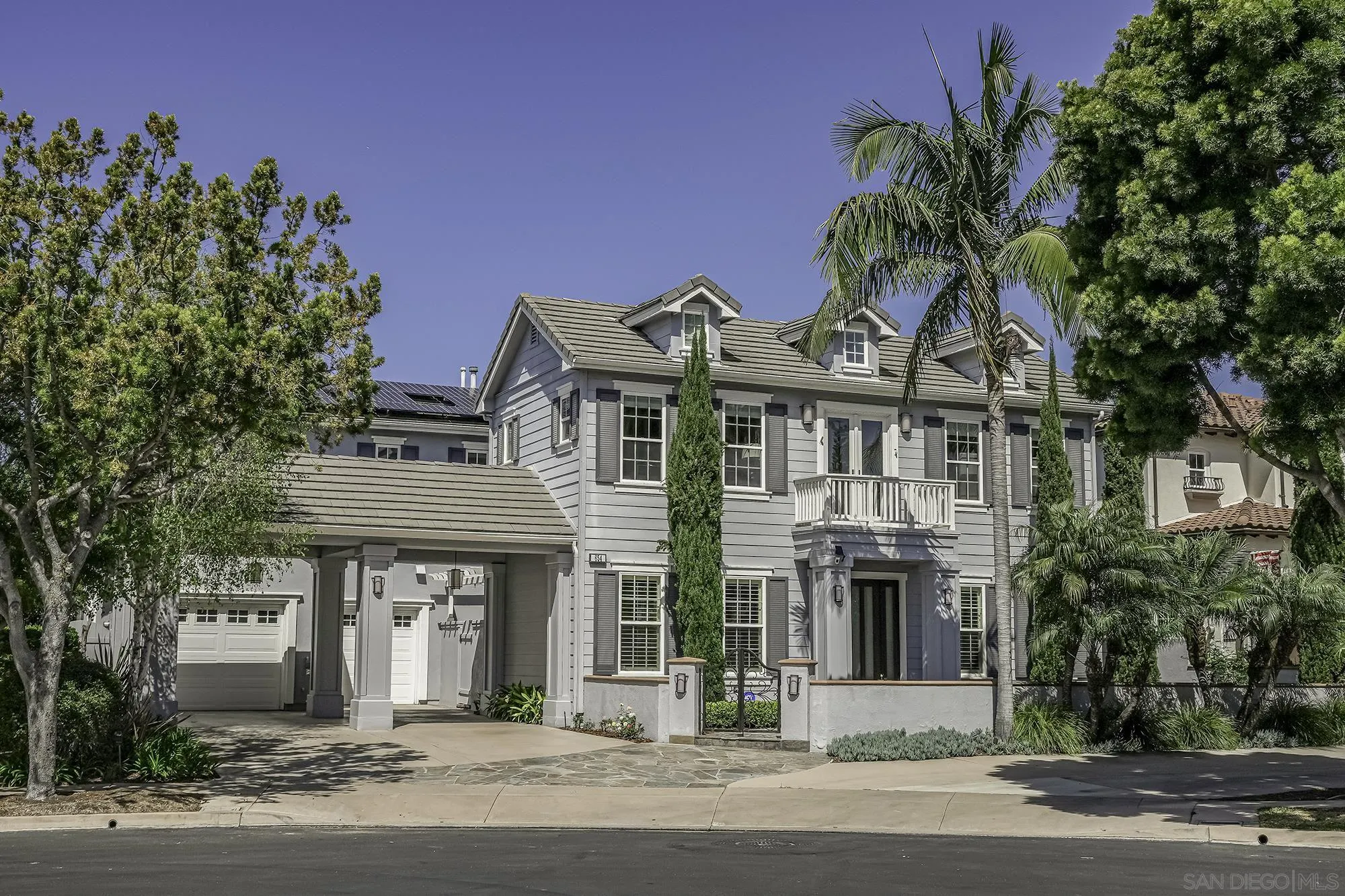 a front view of a house with a garden
