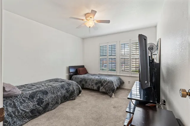 a spacious bedroom with a bed and a chandelier