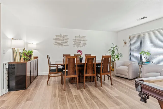 a dining room with furniture and wooden floor