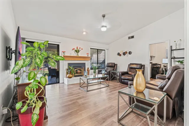a living room with furniture a fireplace and a flat screen tv