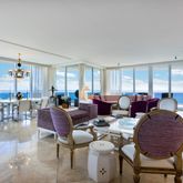 a living room with lots of furniture and a large window