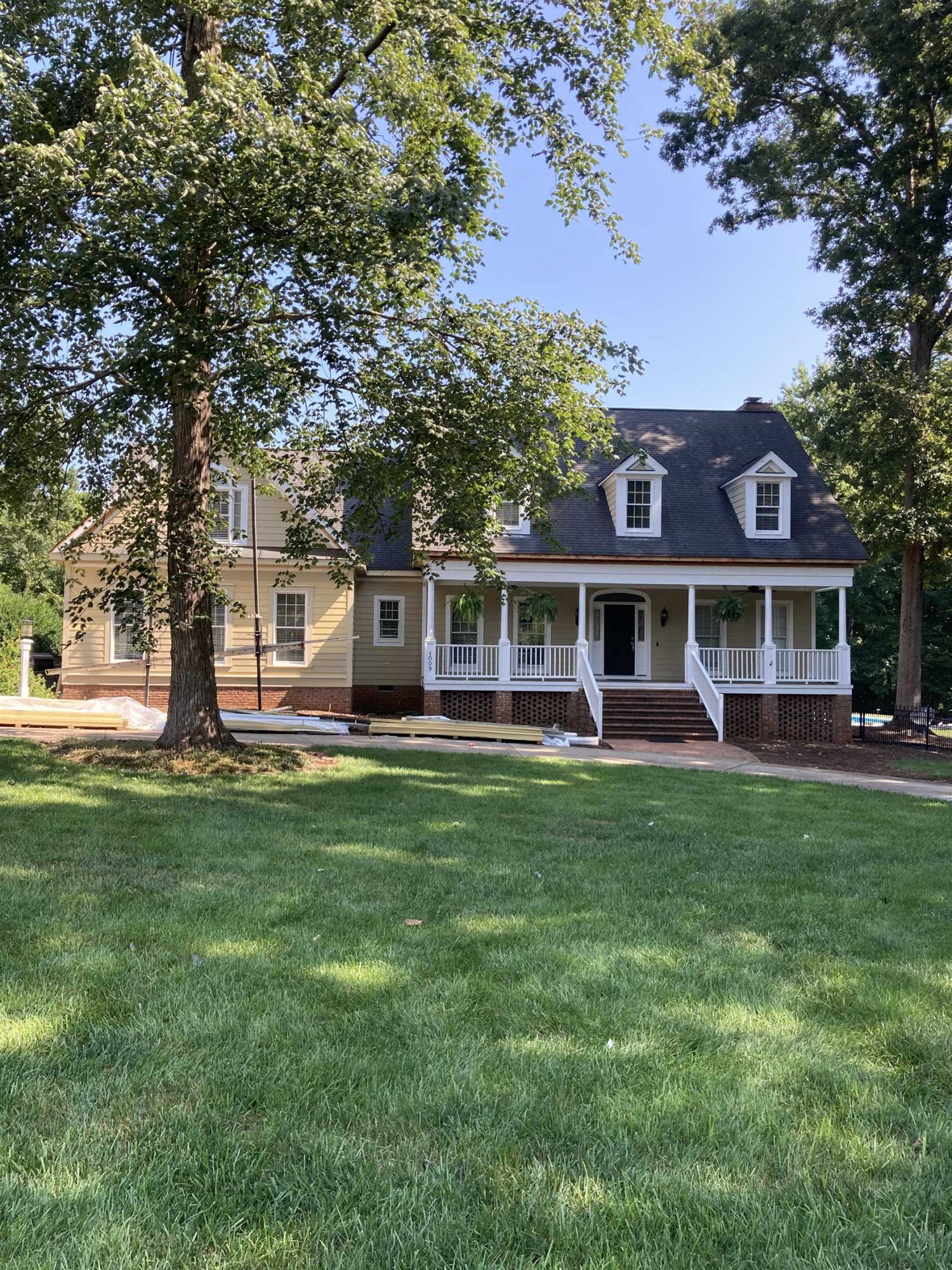 1009 Oak Creek Road Raleigh, NC 27615 - Photo 1 of 3 a front view of a house with a garden