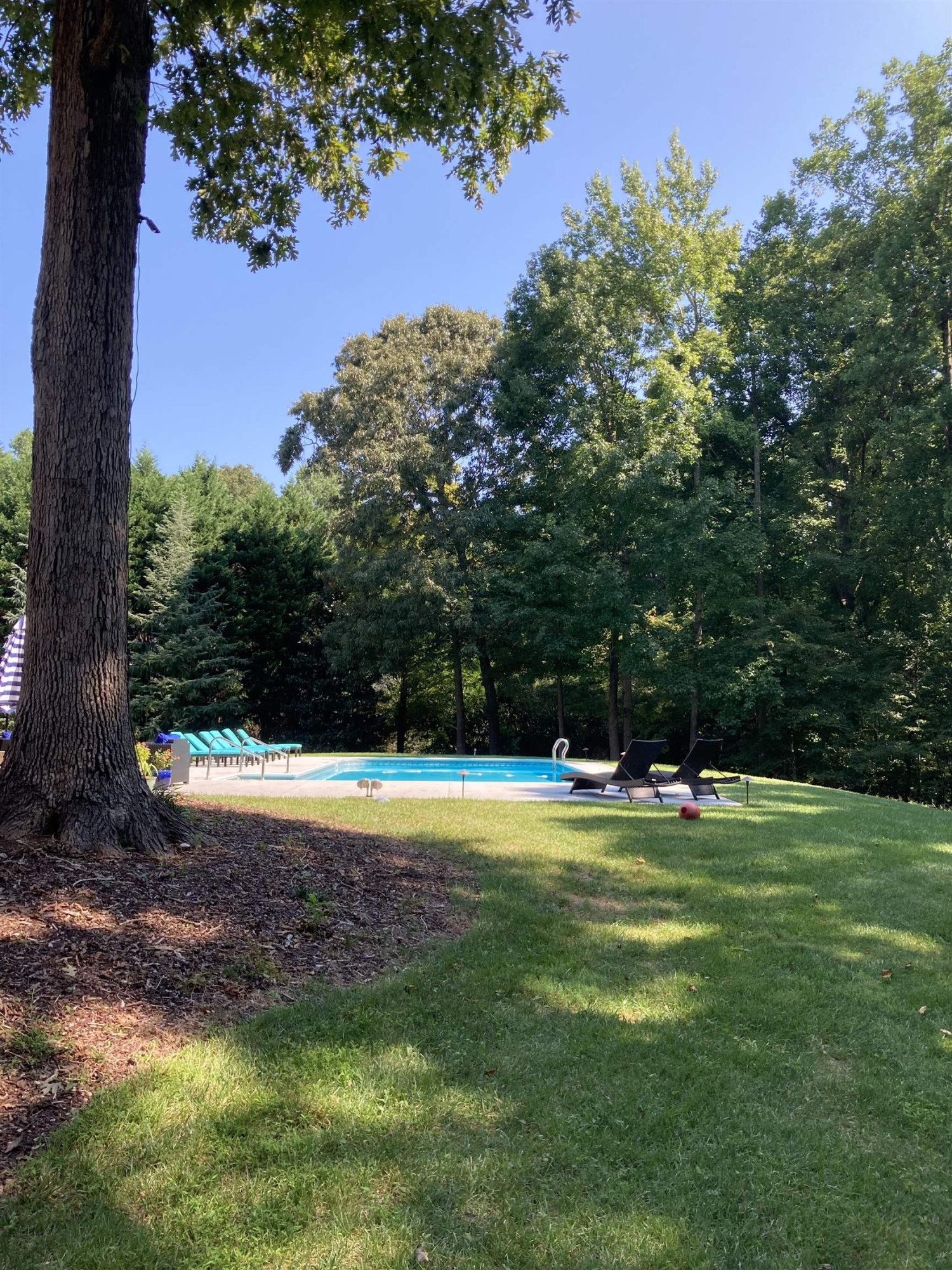 1009 Oak Creek Road Raleigh, NC 27615 - Photo 2 of 3 a view of a swimming pool with an outdoor space and seating area