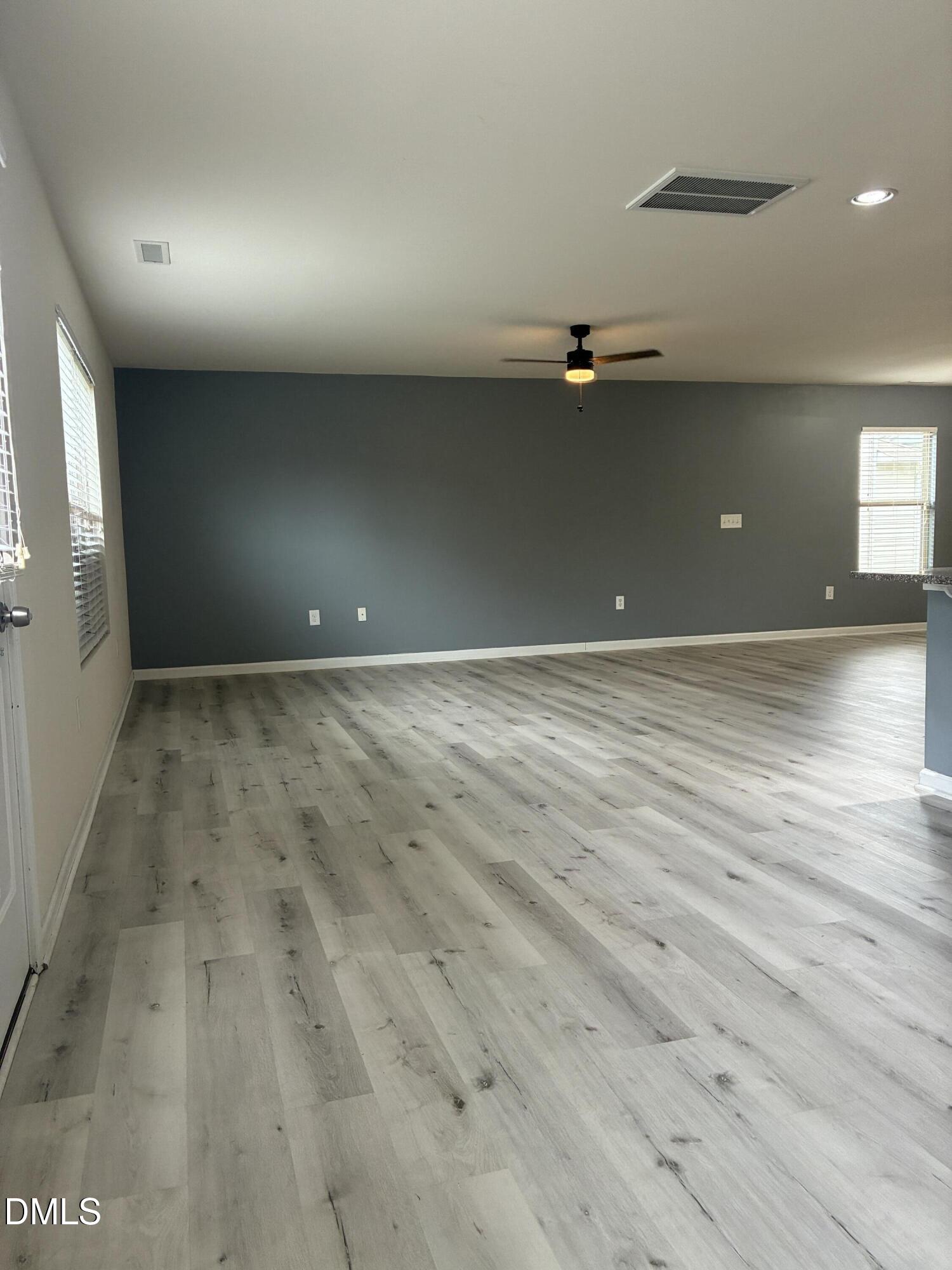 4325 Lyman Avenue Raleigh, NC 27616 - Photo 11 of 52 an empty room with wooden floor and windows