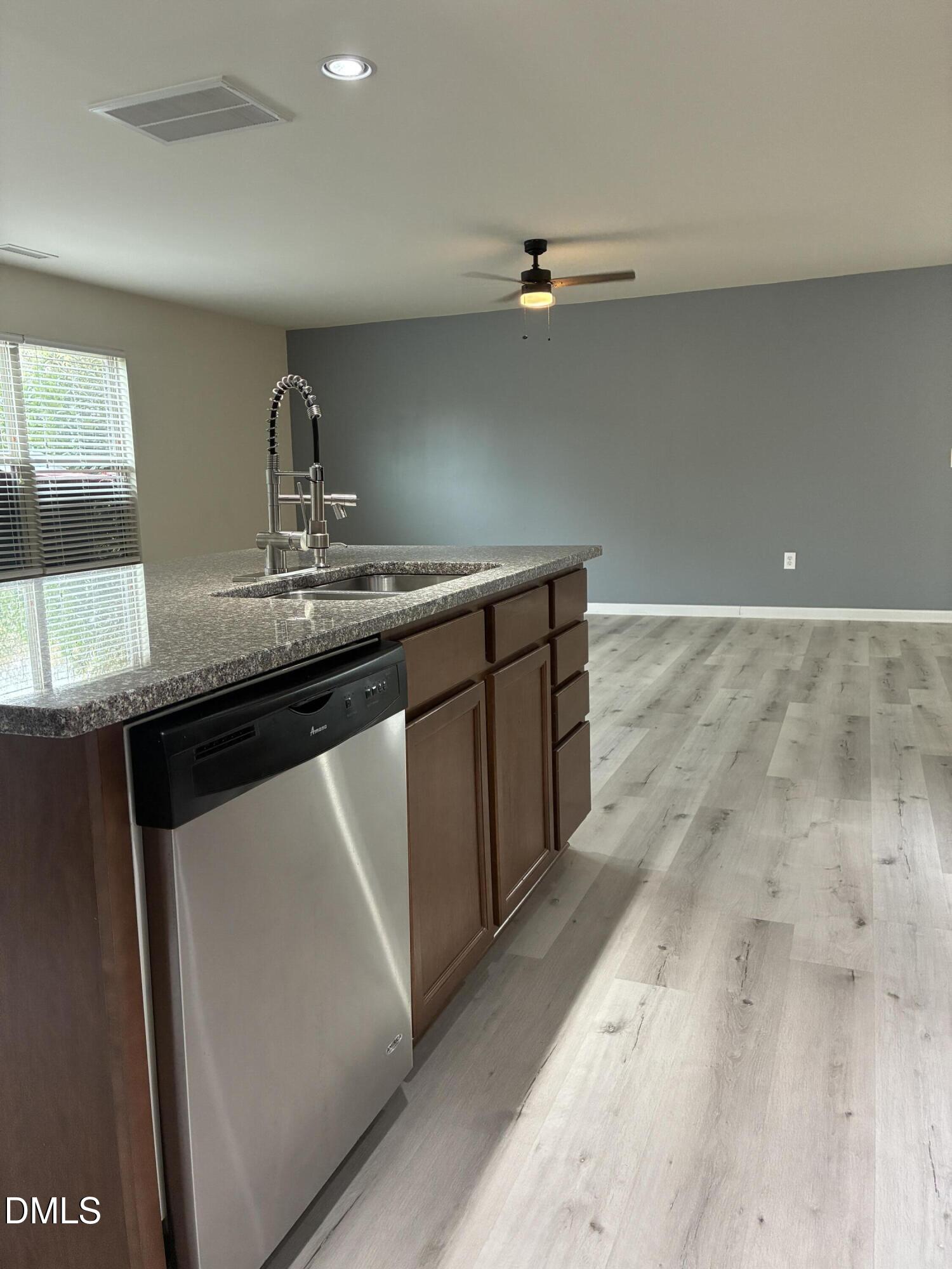 4325 Lyman Avenue Raleigh, NC 27616 - Photo 12 of 52 a kitchen with a sink a stove and cabinets