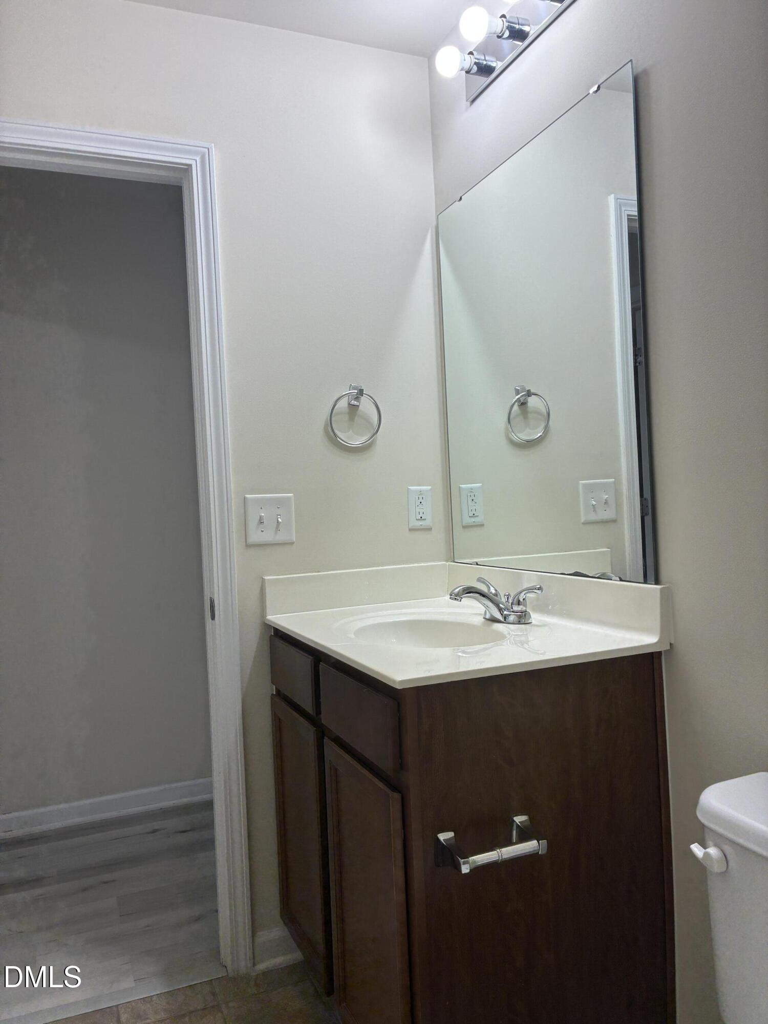 4325 Lyman Avenue Raleigh, NC 27616 - Photo 18 of 52 a bathroom with a sink and a mirror