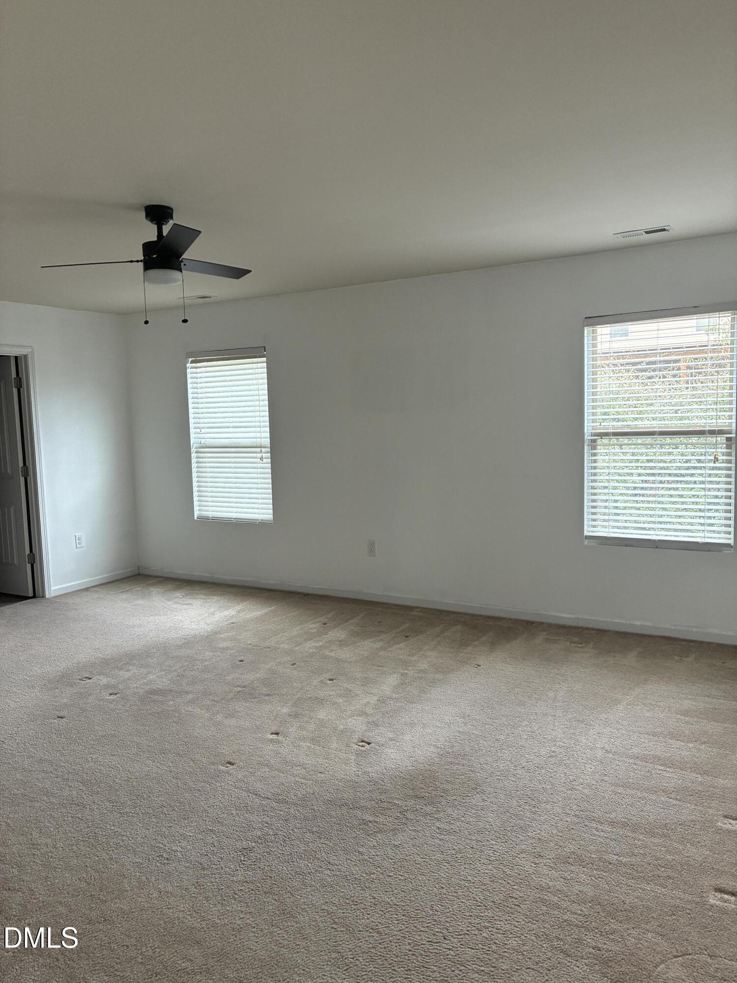4325 Lyman Avenue Raleigh, NC 27616 - Photo 28 of 52 an empty room with windows and ceiling fan