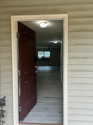 a view of hallway with wooden floor