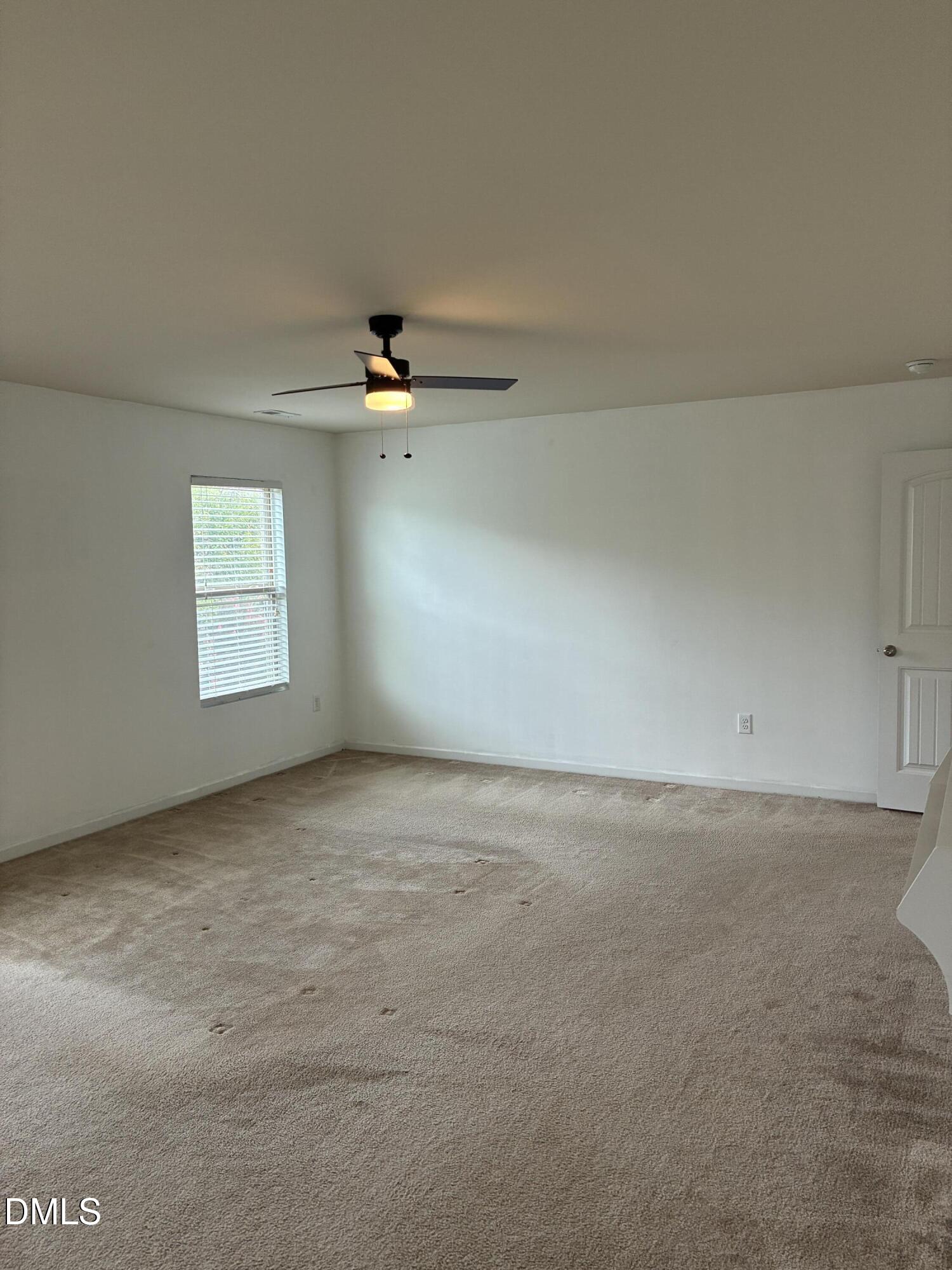 4325 Lyman Avenue Raleigh, NC 27616 - Photo 31 of 52 an empty room with a window and a ceiling fan
