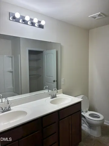 a bathroom with a double vanity sink and a mirror