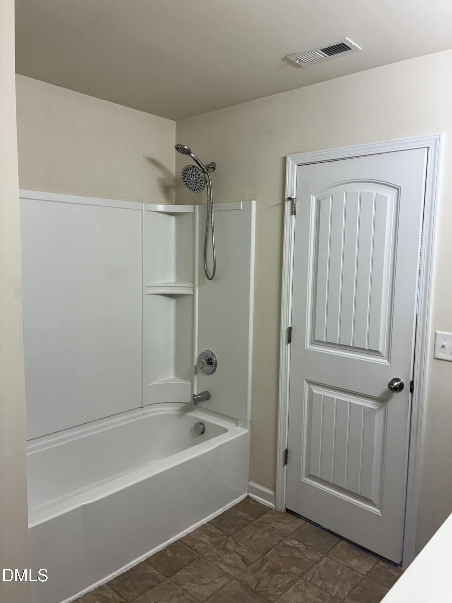 4325 Lyman Avenue Raleigh, NC 27616 - Photo 38 of 52 a bathroom with a bathtub and a shower