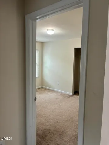 an empty room with a empty space and windows