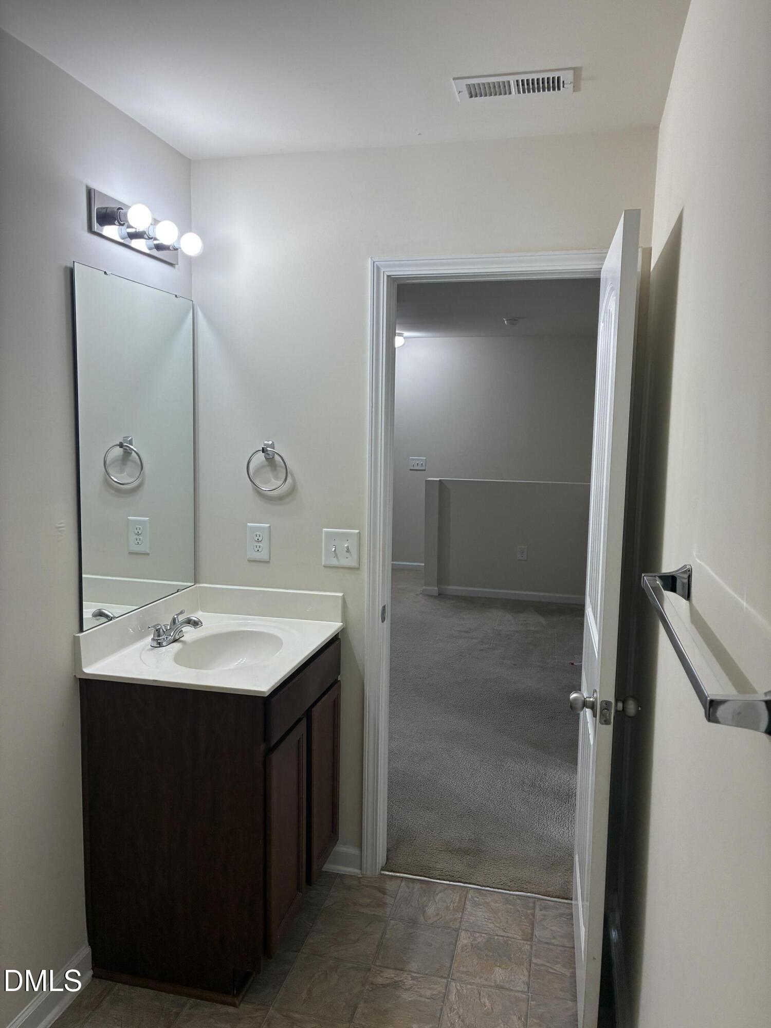 4325 Lyman Avenue Raleigh, NC 27616 - Photo 42 of 52 a bathroom with a sink and a mirror