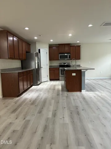 a view of kitchen with microwave and cabinets