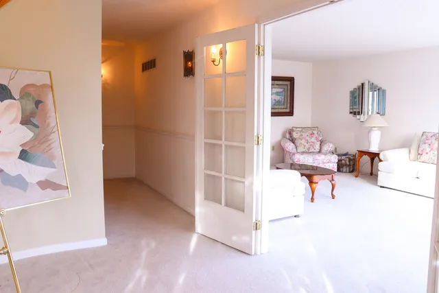 a view of a dining room with furniture and chandelier