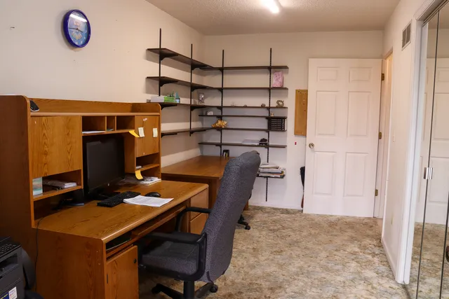 a bathroom with a granite countertop sink and a window