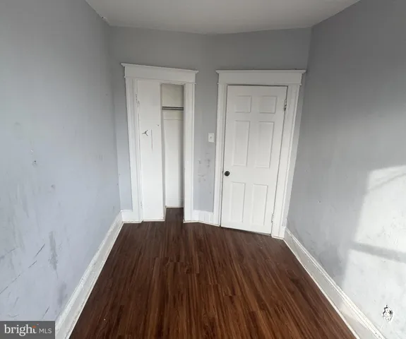 a view of a small space with wooden floor and closet
