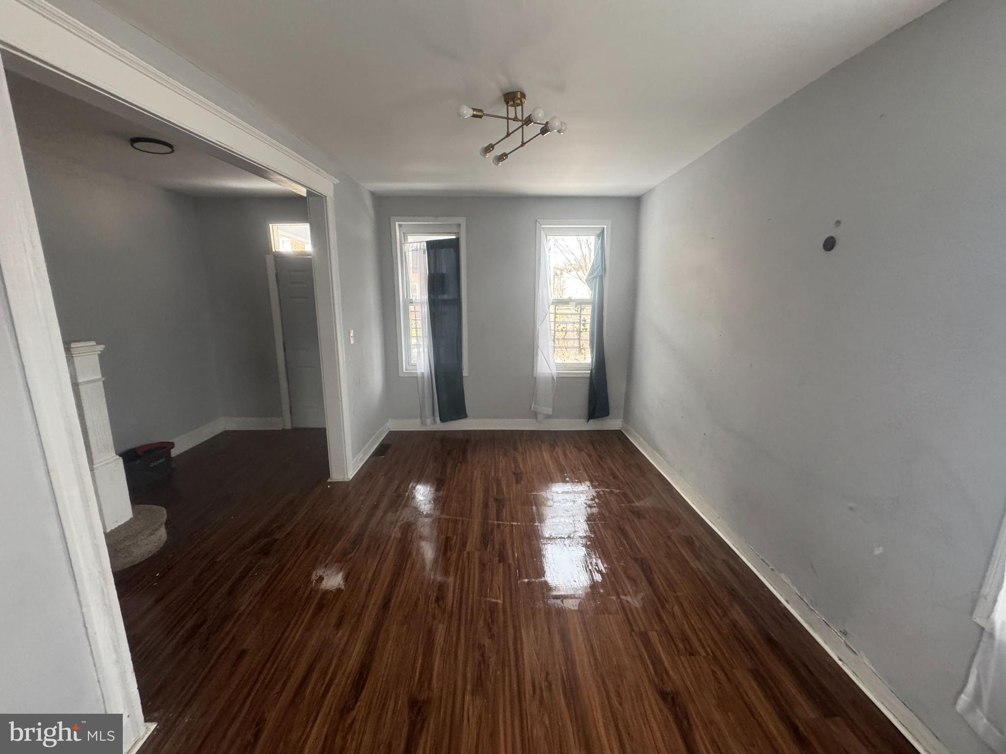 2801 Presbury Street Baltimore, MD 21216 - Photo 4 of 17 a view of a hallway and wooden floor and a chandelier