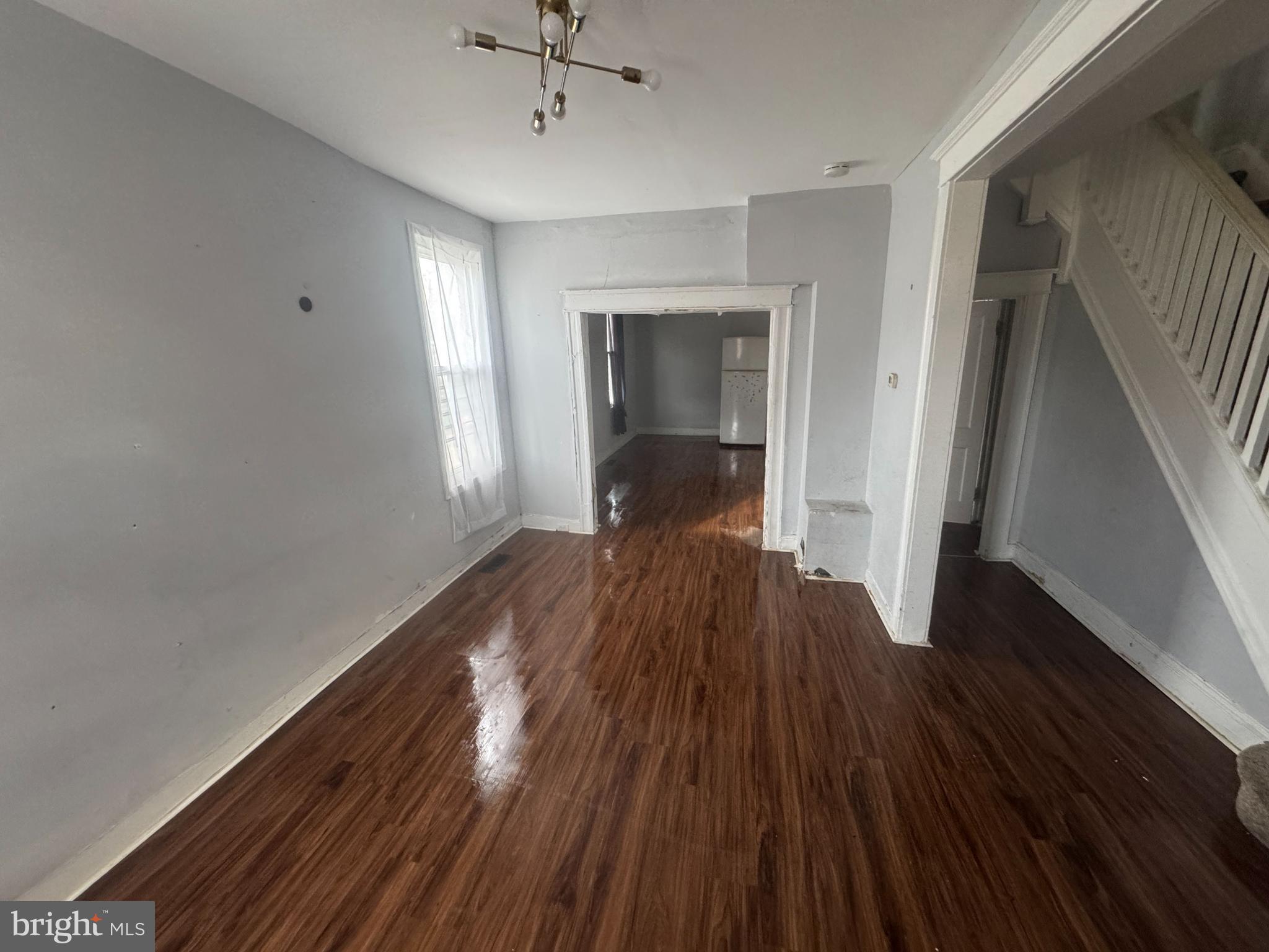2801 Presbury Street Baltimore, MD 21216 - Photo 5 of 17 a view of a room with wooden floor and staircase