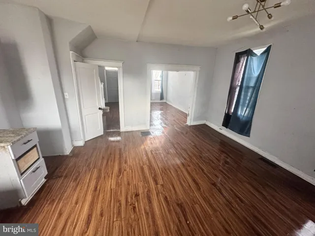 a view of a room with wooden floor and staircase