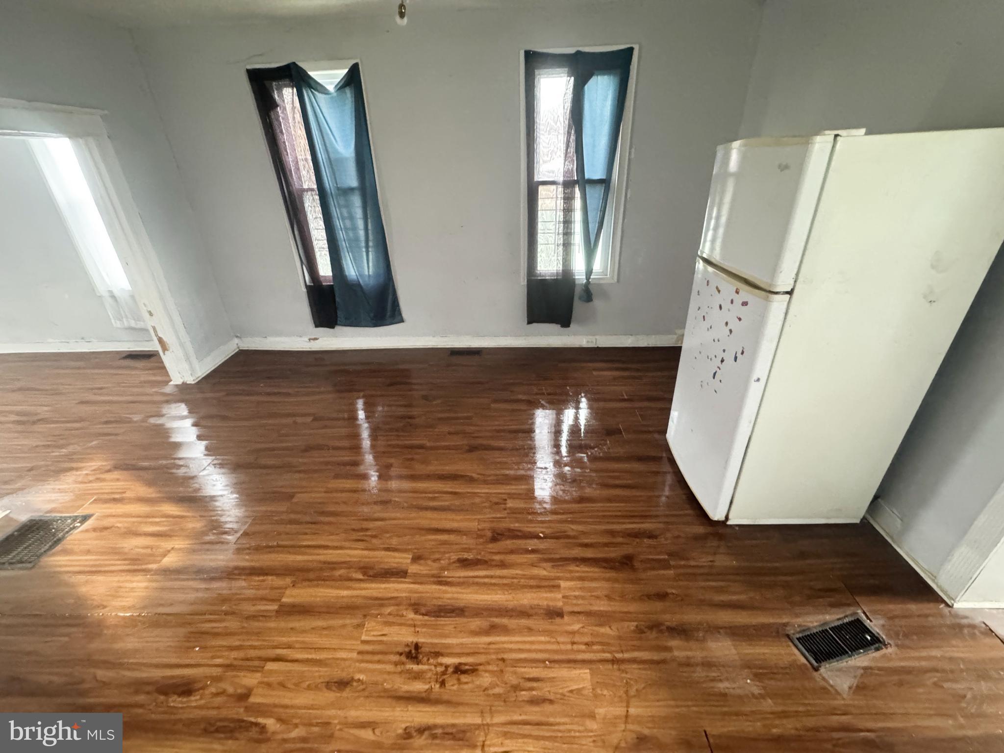2801 Presbury Street Baltimore, MD 21216 - Photo 8 of 17 a view of a livingroom with wooden floor and a large window