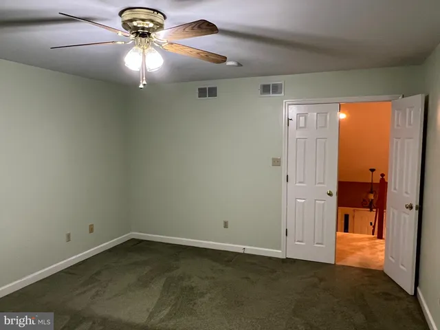 an empty room and a bathroom