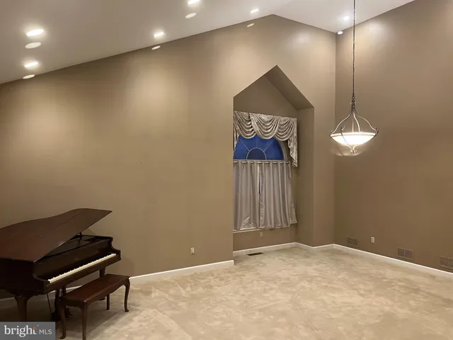 a view of a hallway with a projector and furniture