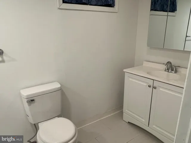a white toilet sitting next to a white sink