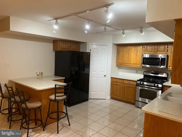 a kitchen with stainless steel appliances a stove a sink refrigerator and a stove