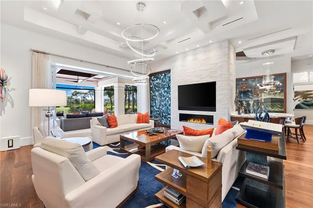 a living room with patio furniture and a flat screen tv