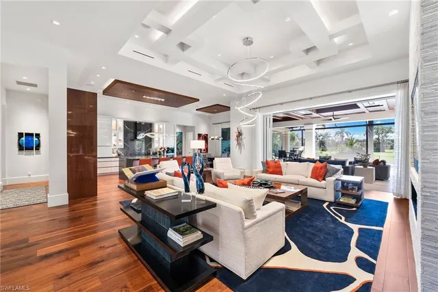 a living room with lots of furniture and kitchen view