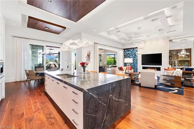 a kitchen with stainless steel appliances granite countertop a sink and a stove