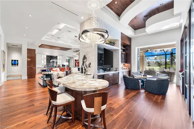 a dining table with chairs and view of kitchen