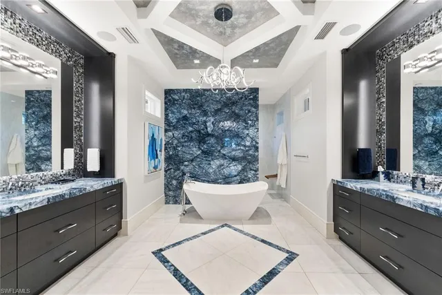 a spacious bathroom with a tub a double vanity sink and a mirror