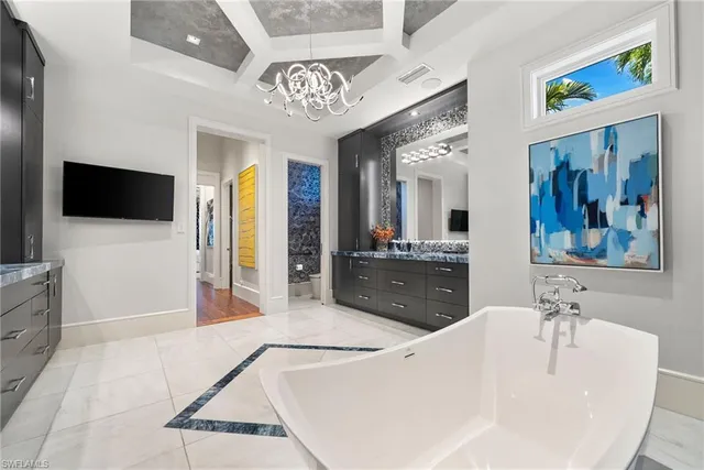 a spacious bathroom with a granite countertop sink mirror and bathtub