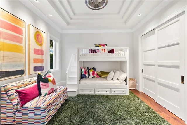 a living room with a couch and a book shelf