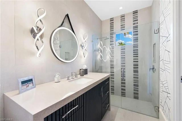 a spacious bedroom with a large bed and a chandelier