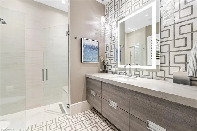 a bedroom with a bed lamp and a large window with garden view