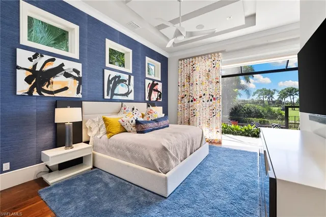 a bedroom with a bed and wall painting on the wall