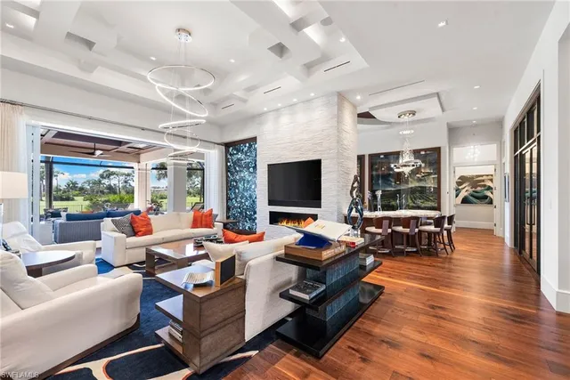 a living room with furniture wooden floor and a flat screen tv