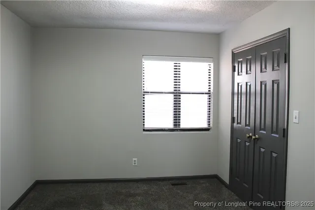 a view of a hallway with an entryway door