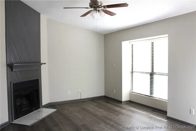 a view of a yard with wooden fence and trees