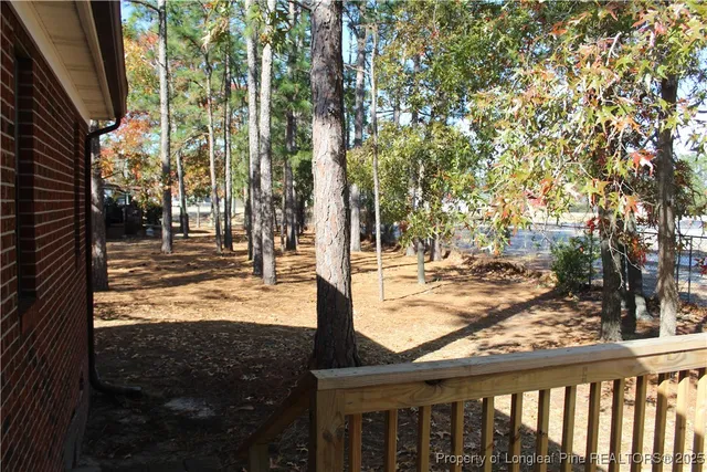 a view of balcony with wooden floor and fence