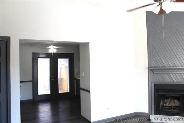 a view of a hallway with wooden floor and a fireplace