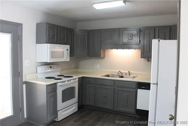 a kitchen with stainless steel appliances a stove a sink and a refrigerator