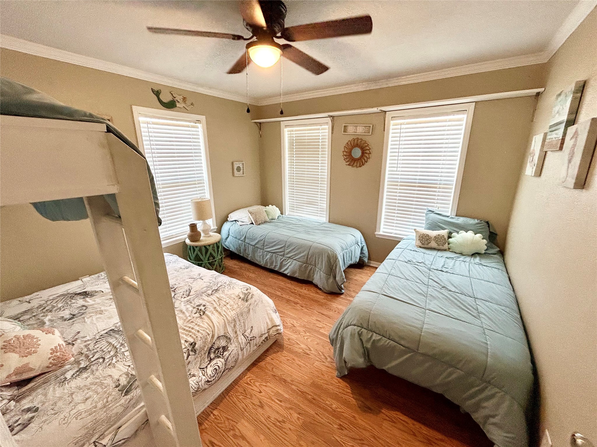151 Neptune Sargent, TX 77414 - Photo 6 of 26 a bedroom with two beds and a chandelier