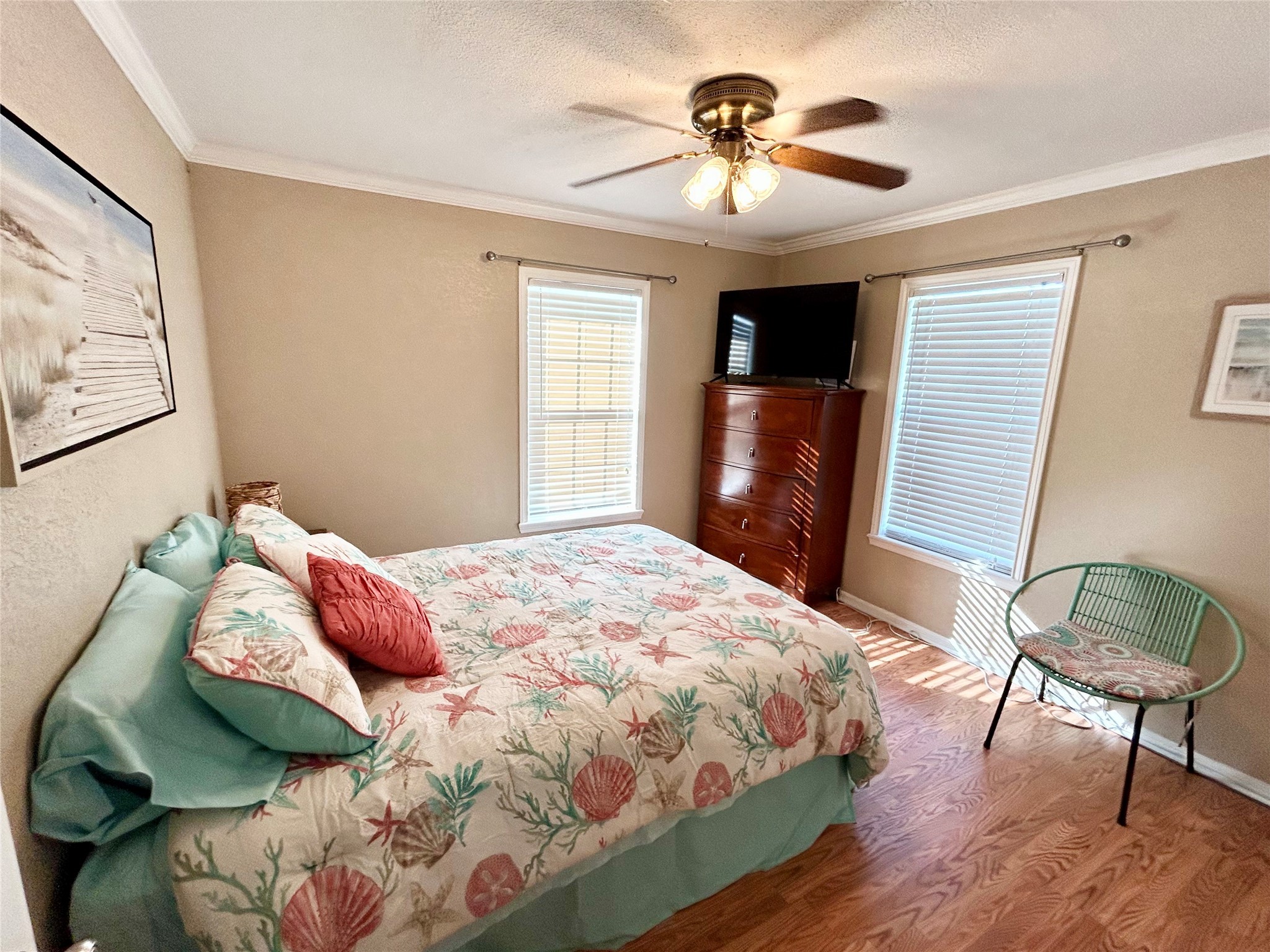 151 Neptune Sargent, TX 77414 - Photo 7 of 26 a bedroom with a bed and a chandelier