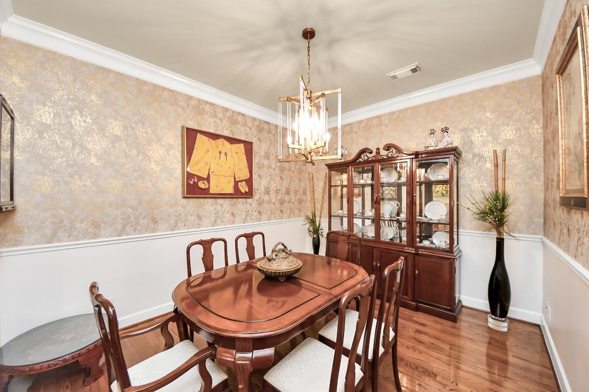 6302 Hermann Lake Drive Houston, TX 77021 - Photo 14 of 50 a dining room with furniture a chandelier and wooden floor