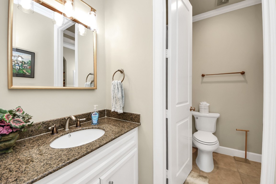 6302 Hermann Lake Drive Houston, TX 77021 - Photo 35 of 50 a bathroom with a granite countertop sink toilet and a mirror